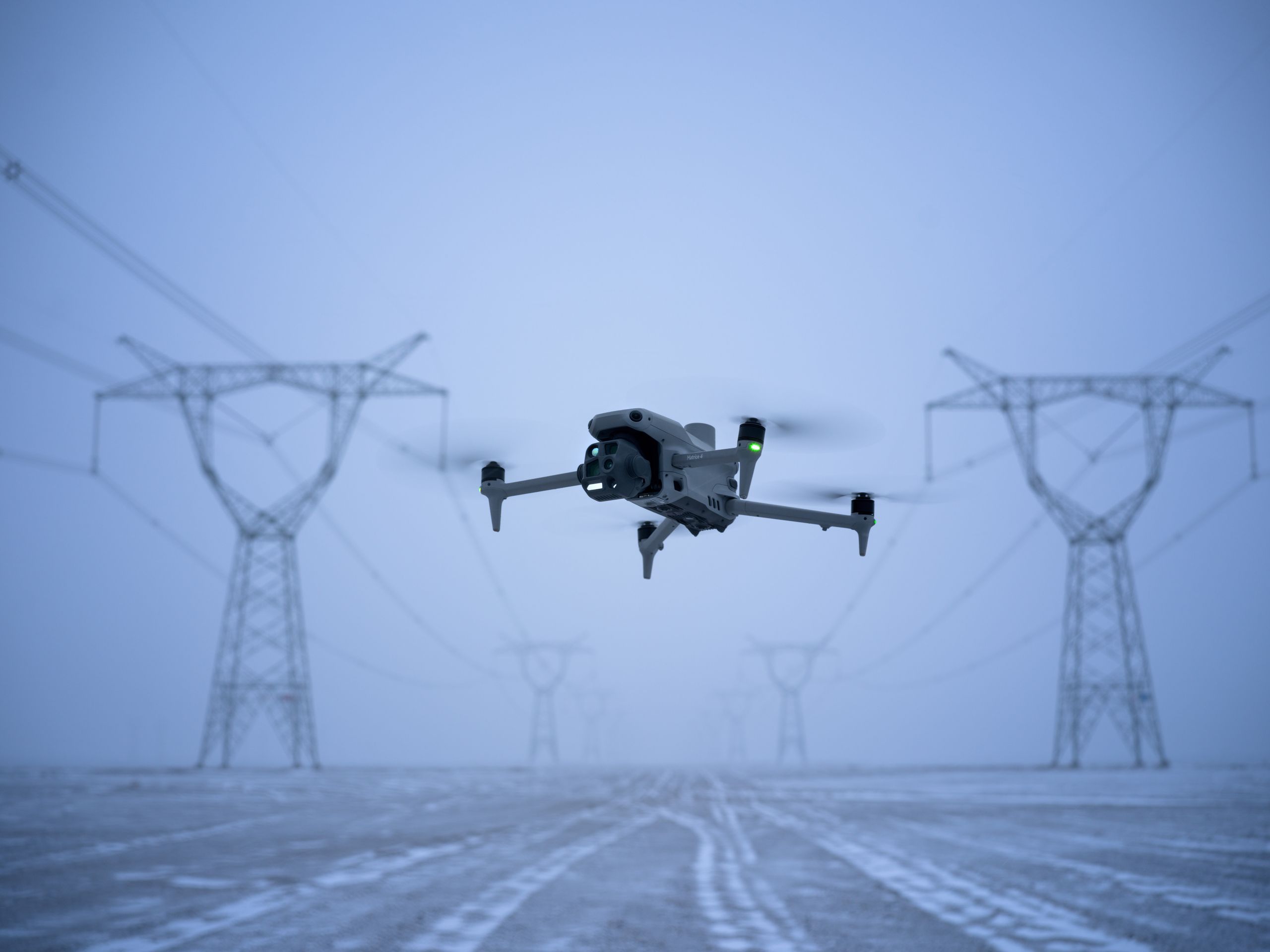 Inspection aircraft hovering over power infrastructure