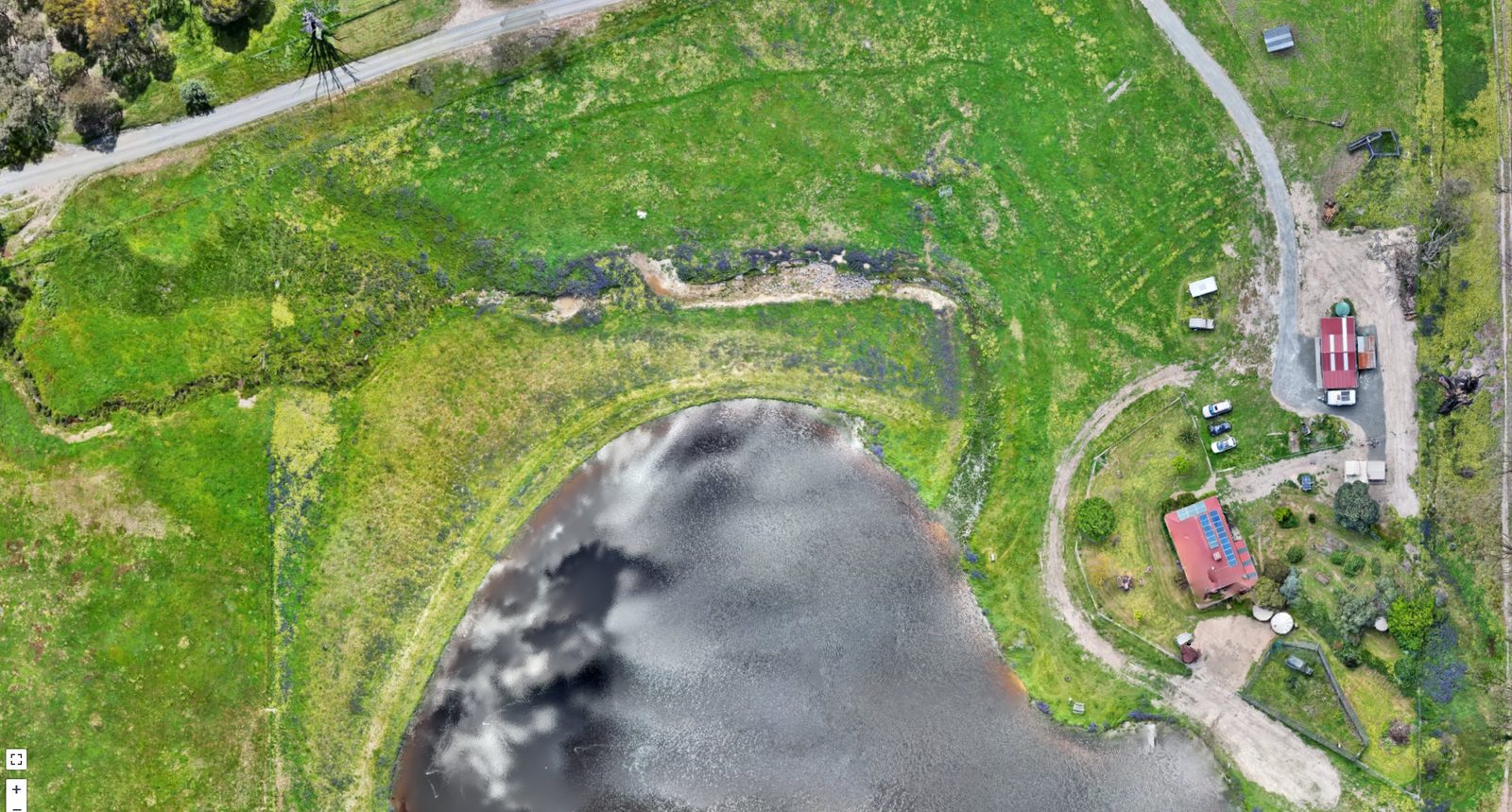 Farm 01 overhead property map showing a large dam, green paddocks, sheds and tracks, Skyhawk Aerial drone imagery
