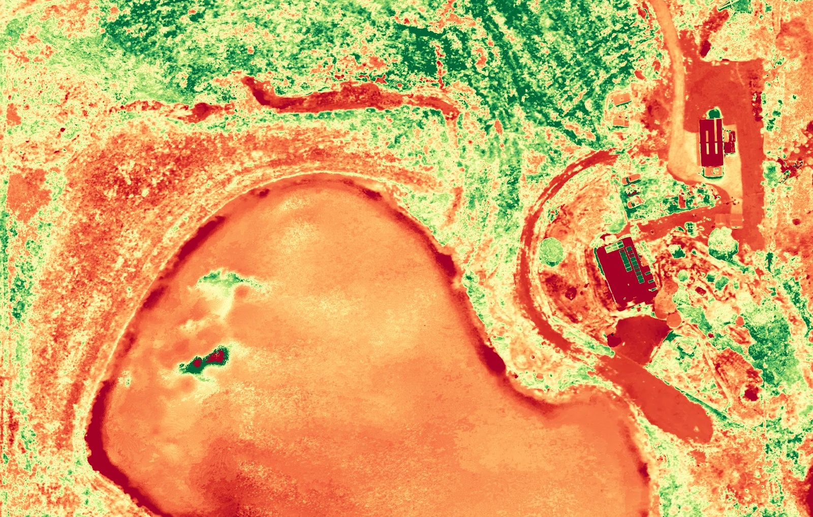Plant health map of Farm 01 showing the dam, paddocks and sheds in red, orange, yellow and green, Skyhawk Aerial drone imagery